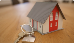 Miniature house next to house keys
